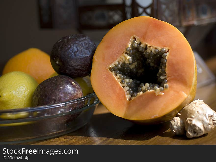 Still life of a fresh pawpaw and passionfruit