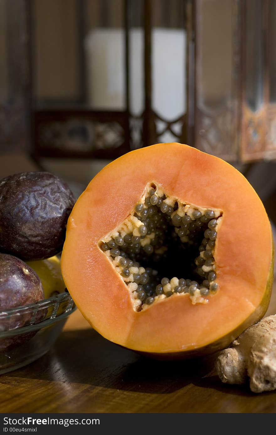 Portrai format still life of a fresh pawpaw and passionfruit