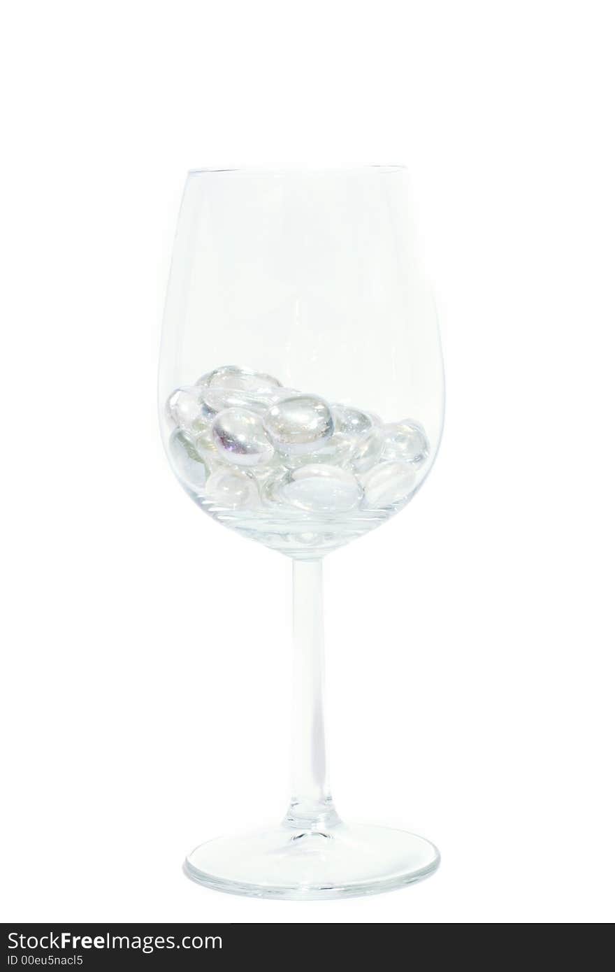 Sparkling stones in a wine glass isolated on white. Sparkling stones in a wine glass isolated on white