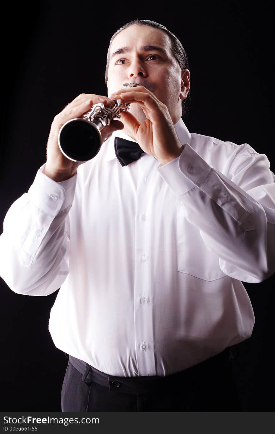 A man playing his wind instrument with expression. A man playing his wind instrument with expression.