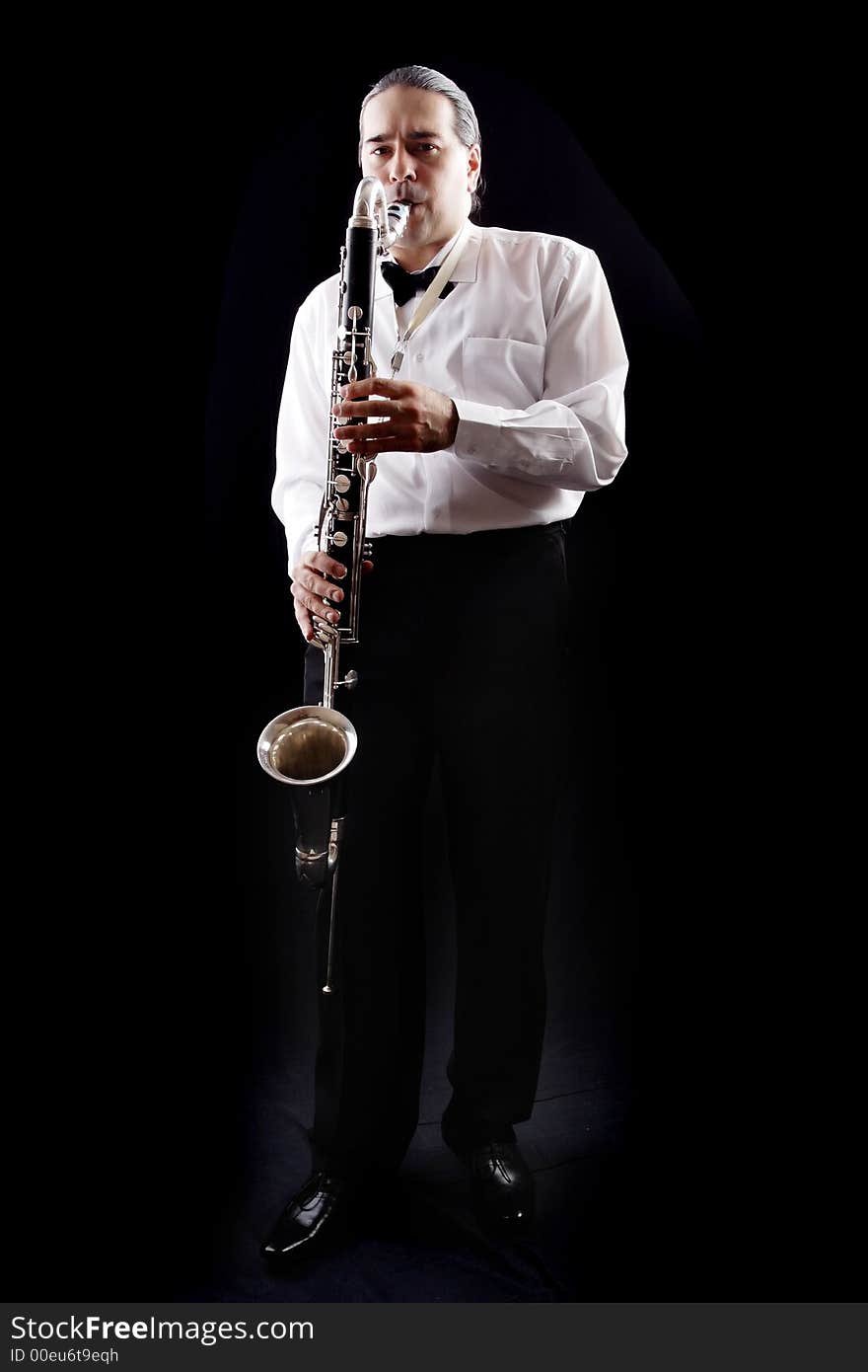 A man playing his wind instrument with expression. A man playing his wind instrument with expression.