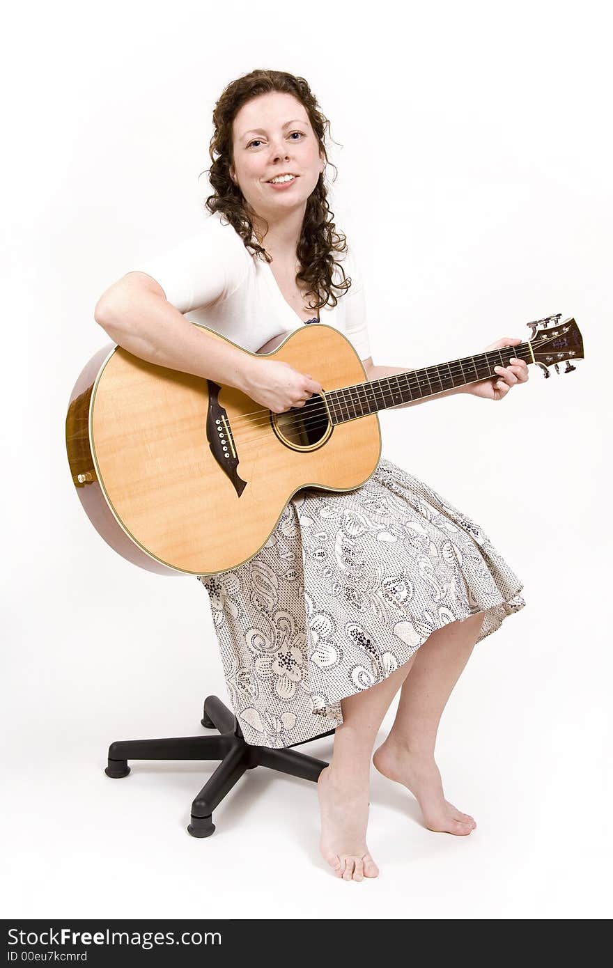 Young woman singing and playing an acoustic guitar. Young woman singing and playing an acoustic guitar