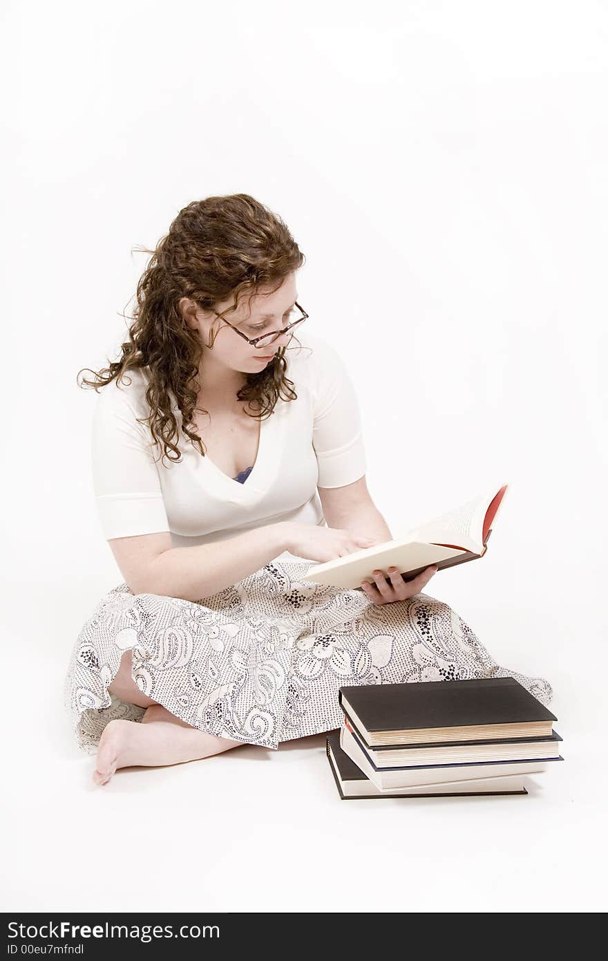 A beautiful young woman studying her books. A beautiful young woman studying her books