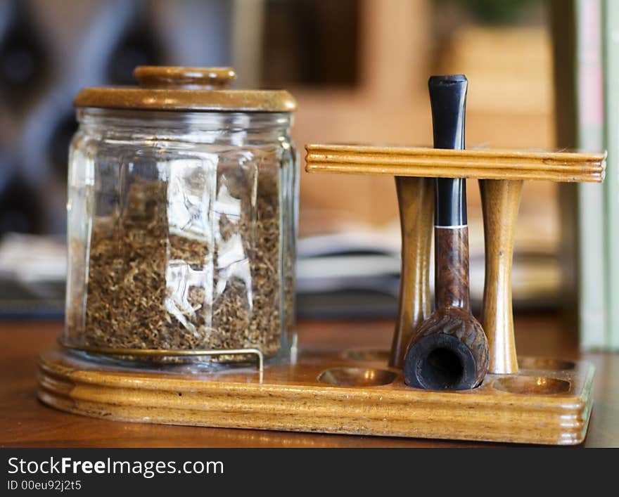 Smoking Pipe with Tobacco on Desk. Smoking Pipe with Tobacco on Desk