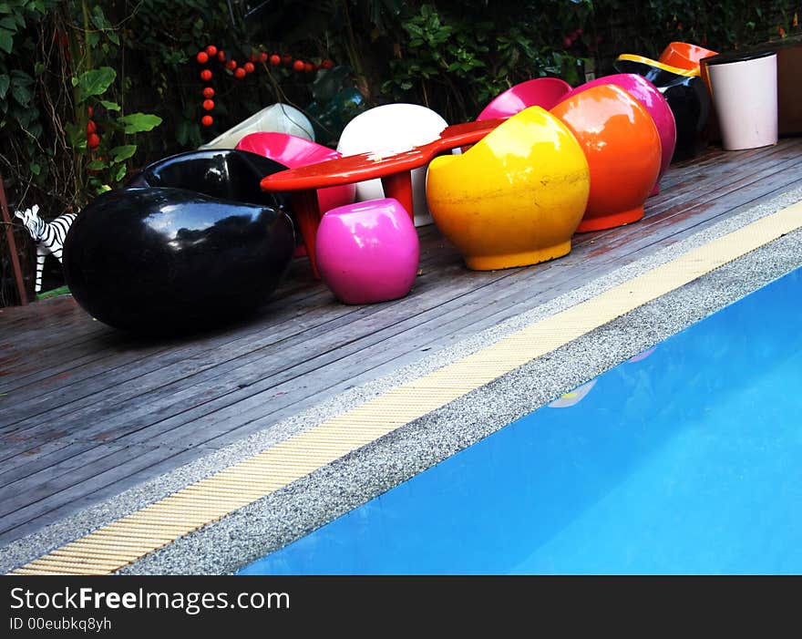 Retro style furniture next to a swimming pool. Retro style furniture next to a swimming pool