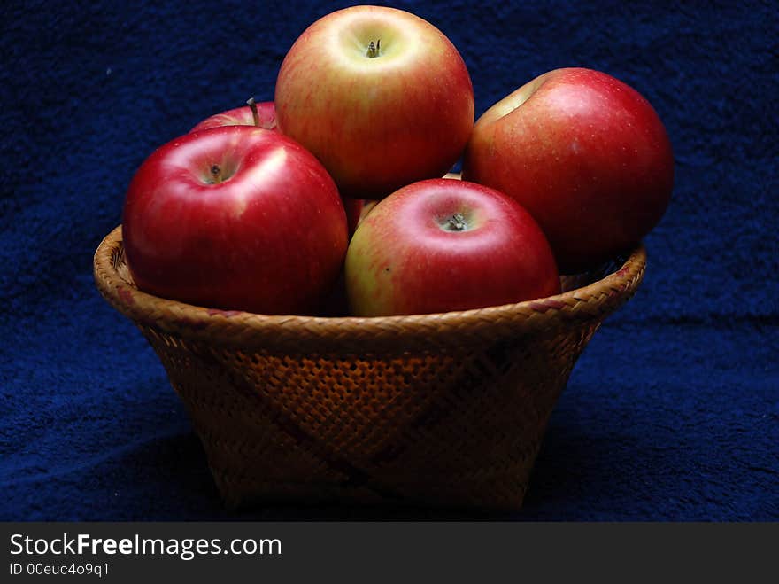 Basket whit apples on dark background