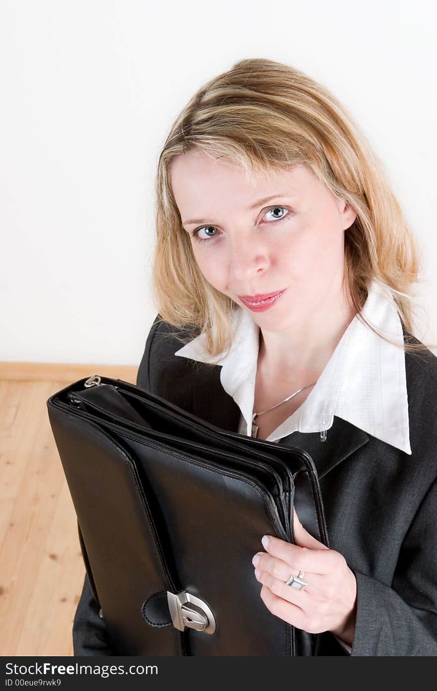 A pretty woman holding a black leather case. A pretty woman holding a black leather case