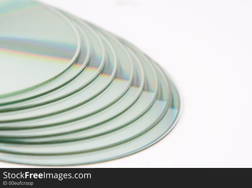 A pile of 9 CDs on a white background