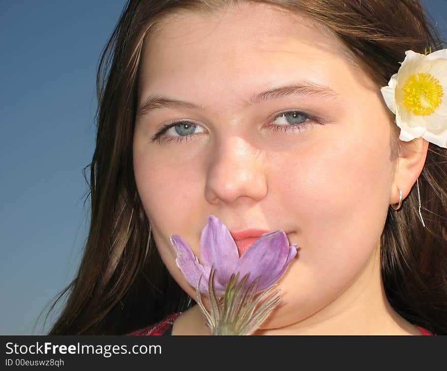 Pretty young girl with the flower in the hair