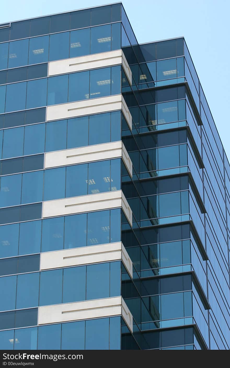 A Blue Glass Building against a  blue sky