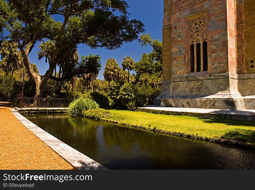 A view of the base beautiful Bok Tower, surrounded by a water moat and housing carillon bells that play every hour for tourist at the popular botanical gardens in Lake Wales, Florida. A view of the base beautiful Bok Tower, surrounded by a water moat and housing carillon bells that play every hour for tourist at the popular botanical gardens in Lake Wales, Florida.