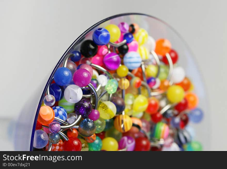 A martini glass full of navel rings. A martini glass full of navel rings