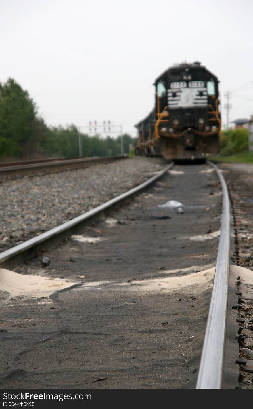 Close up of railroad tracks with locomotive in the background. Close up of railroad tracks with locomotive in the background