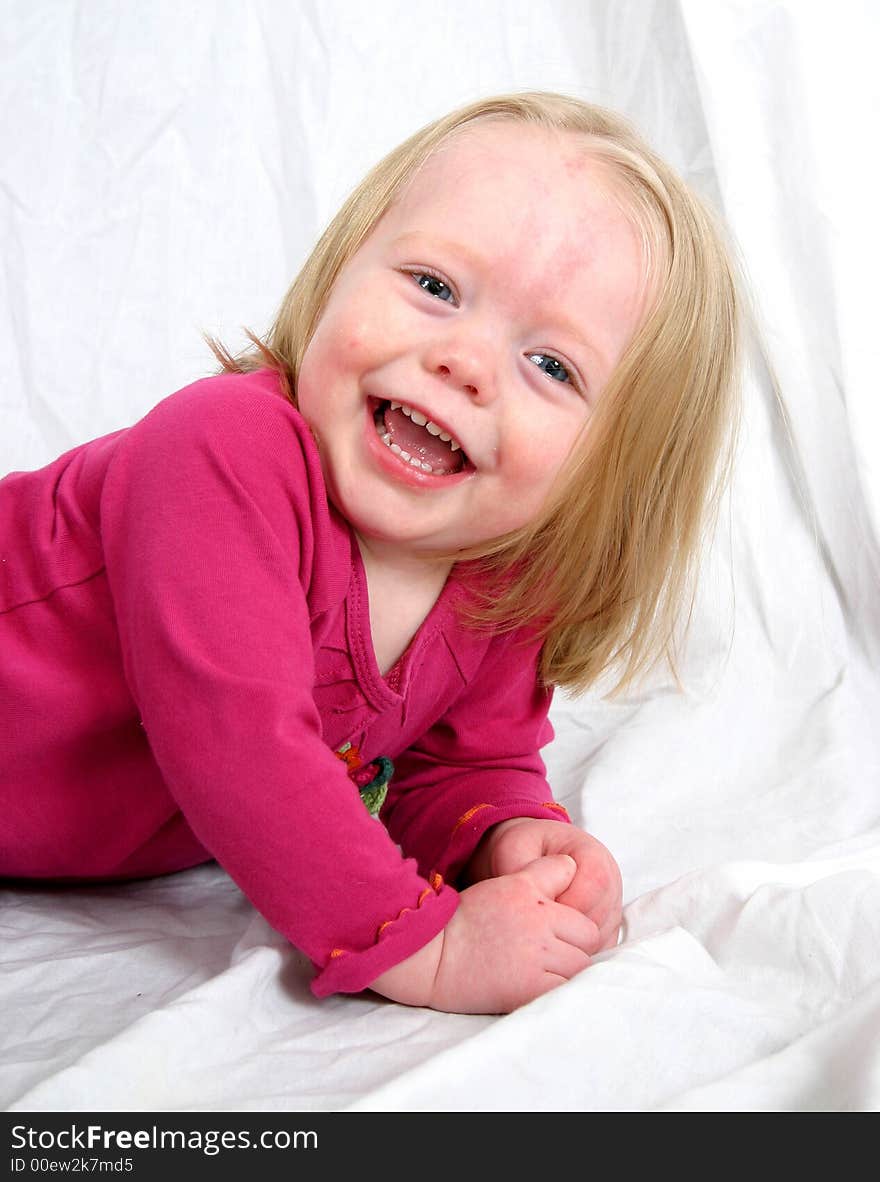 Cute little girl on a white