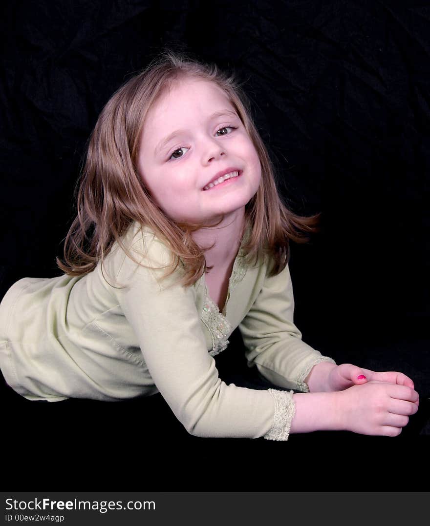 Cute little girl laying on the floor