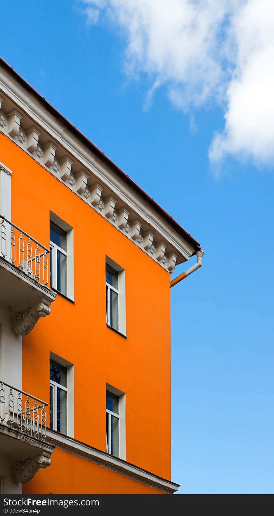 Orange building over bly sky. Orange building over bly sky