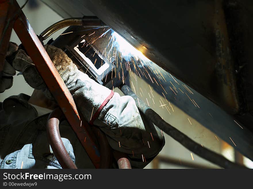 One welder working on steel project. One welder working on steel project