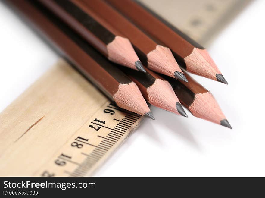 Sharp pencils and ruler on white background