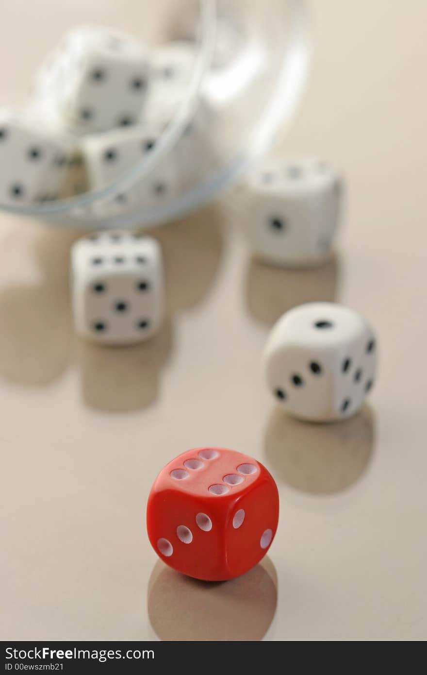 Many white dices and a red one standing alone