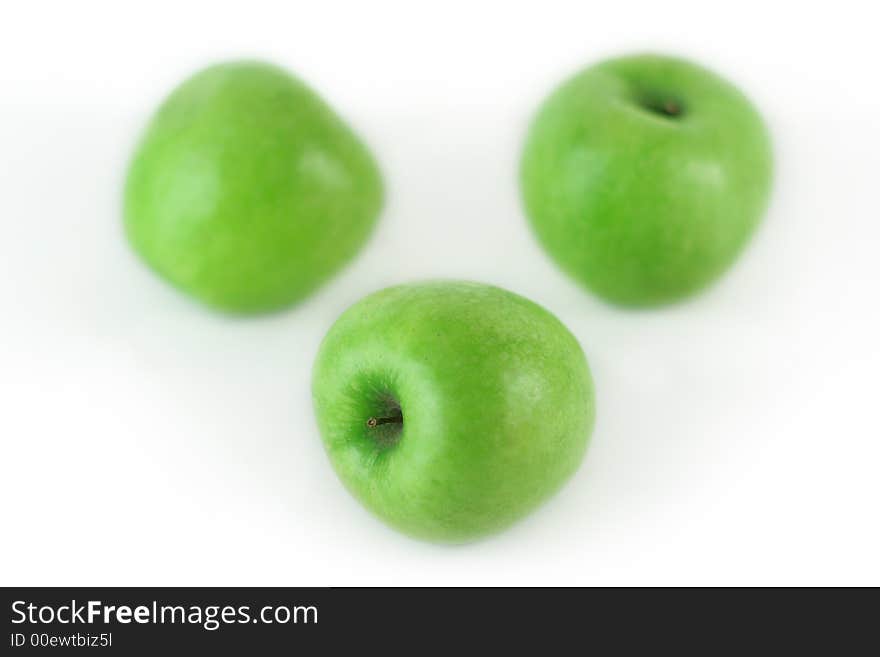 Three fresh green apples on white background