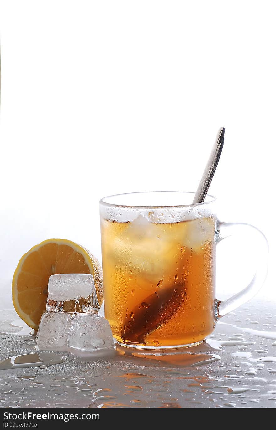 Cold tea, lemon and ice cubes melted in water