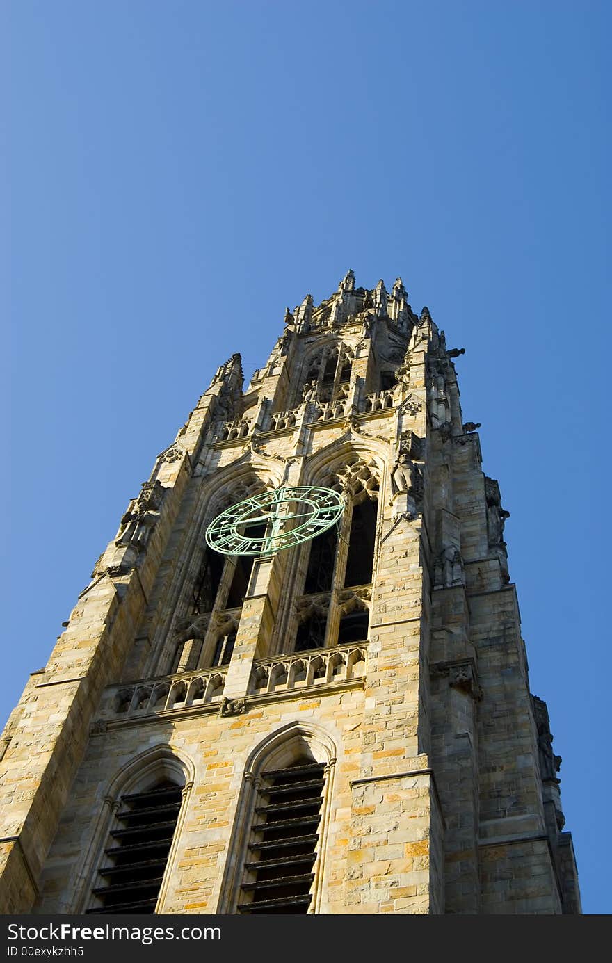 An old college tower against a blue sky