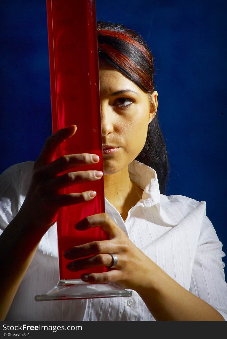 Beautiful female young scientist wearing glasses while doing a blood test