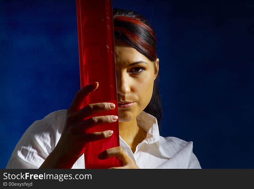 Beautiful female young scientist wearing glasses while doing a blood test