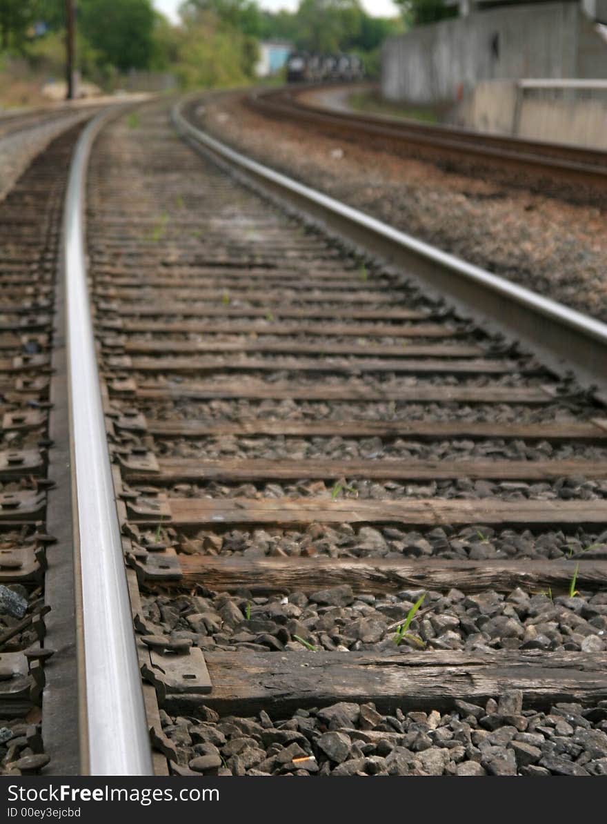 Railroad tracks curving into the distance. Railroad tracks curving into the distance