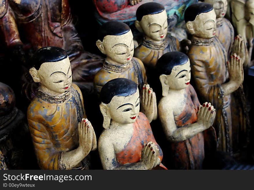 Wooden Buddhist statues in tropical Thailand - travel and tourism