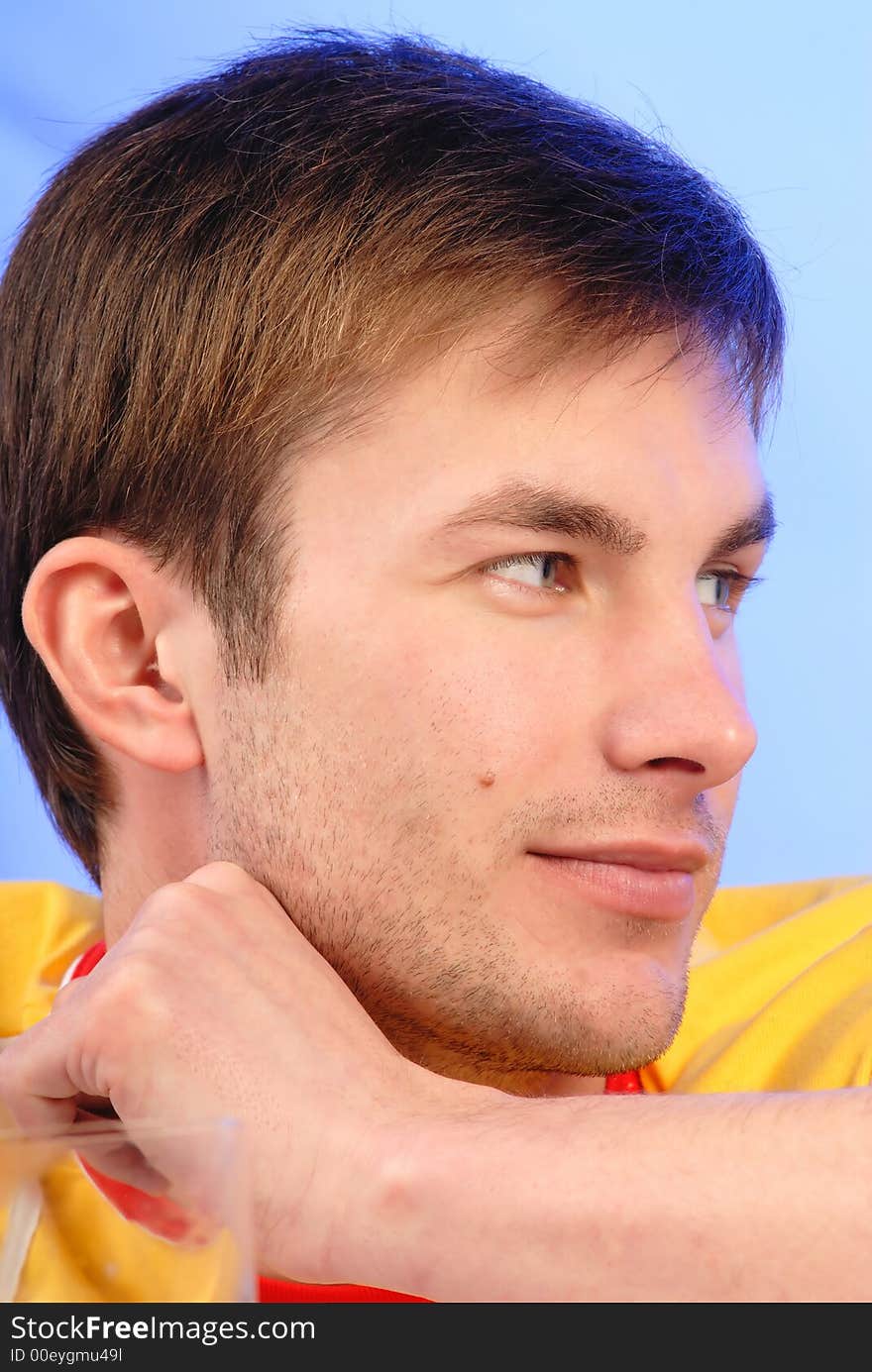 Man's portrait, is dressed in bright clothes on blue background, structure. Man's portrait, is dressed in bright clothes on blue background, structure