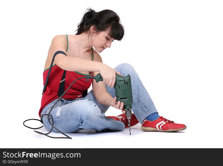 A seriuos woman working with a drill. white background