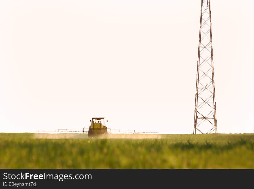 Spraying the Crop. Focus on tractor