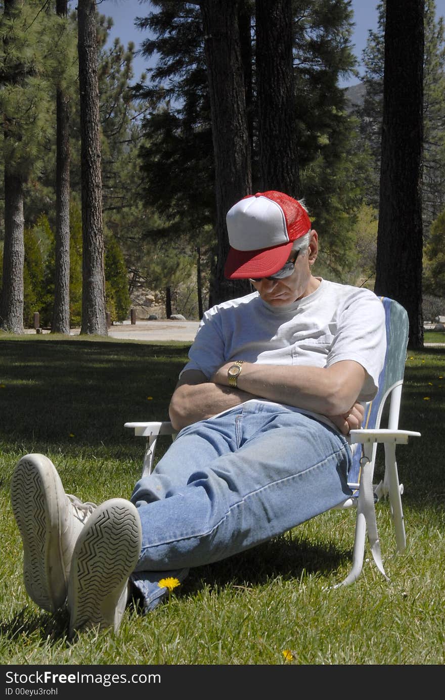 A man is sitting in the chair in forest meadow and dreamind