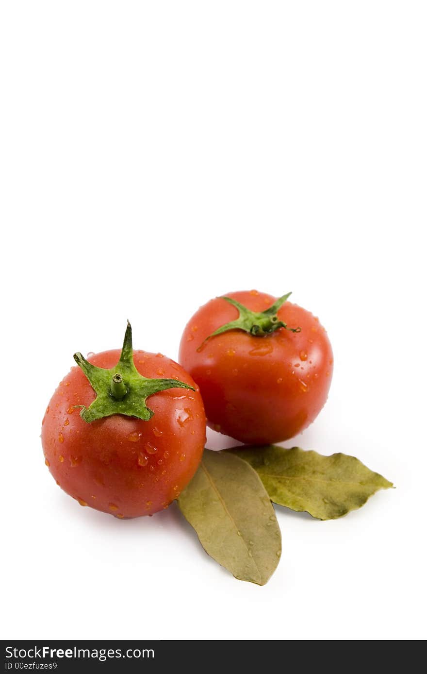 Food ingredients tomatoes and laurel leaves over white background