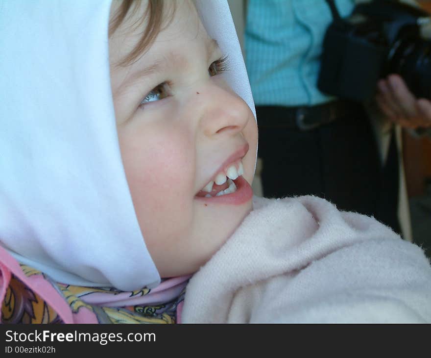 Smiling little girl with head scarf. Smiling little girl with head scarf.