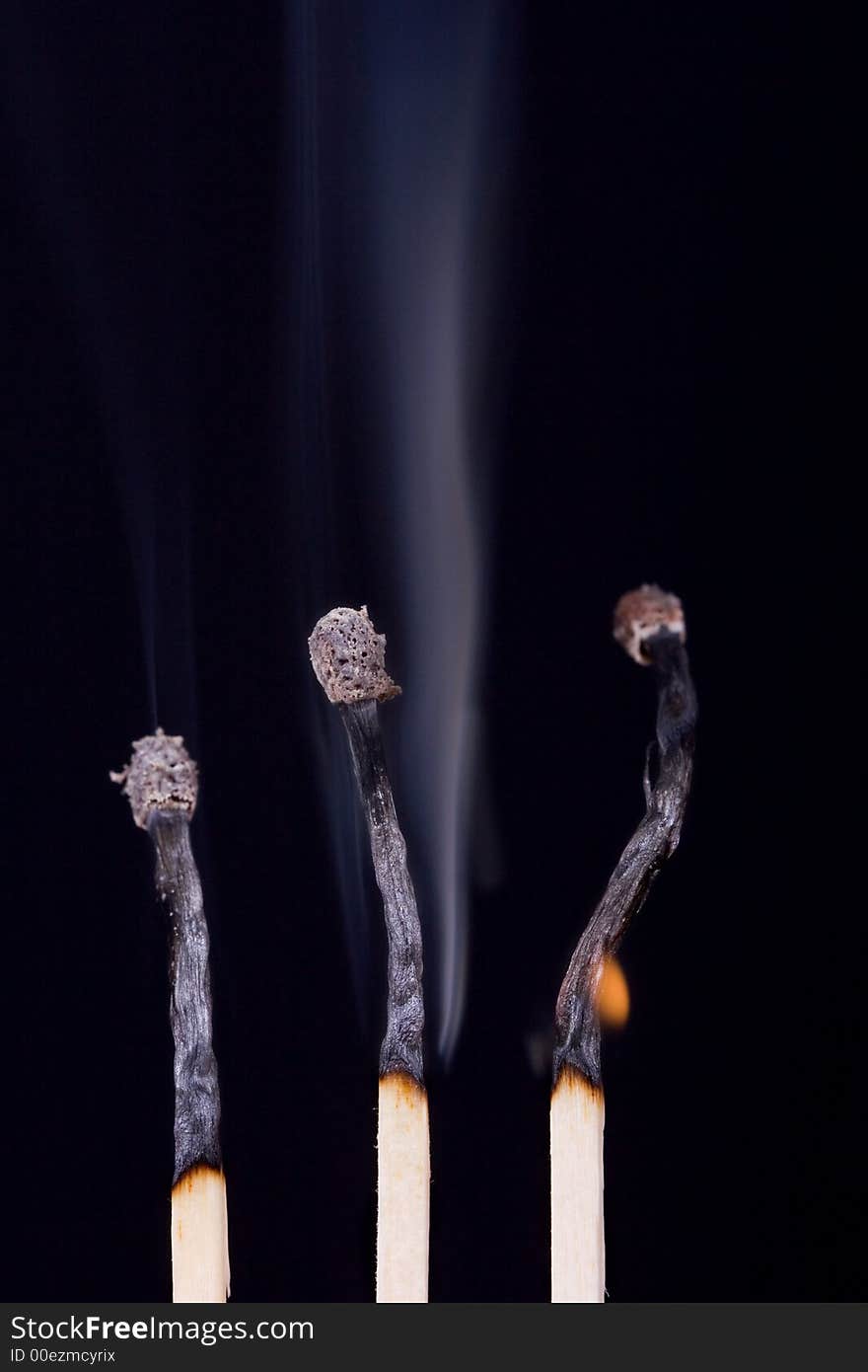 Burned matches over black background. Burned matches over black background