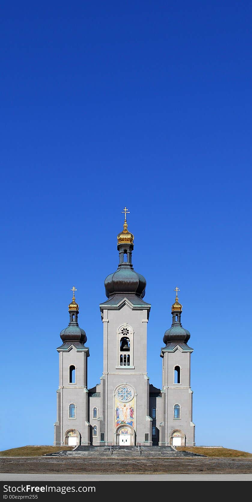 Big rural church/cathedral in field under blue sky. Big rural church/cathedral in field under blue sky