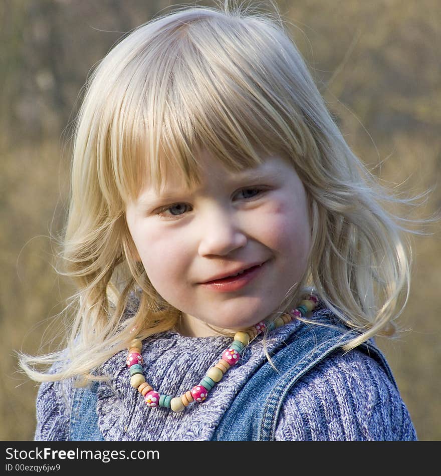 Young blond girl looking thoughtfully. Young blond girl looking thoughtfully