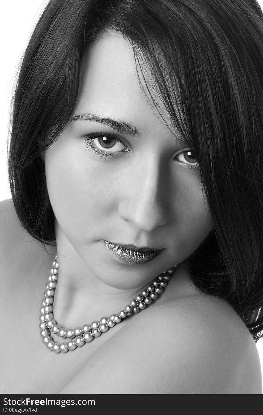 Portrait of the beautiful girl with a beads on a neck over white background