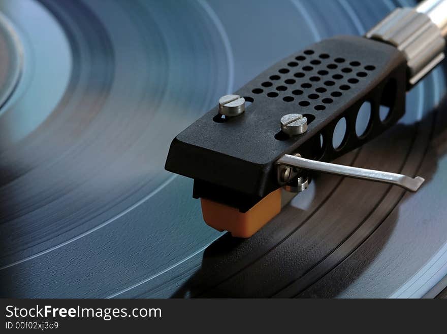 Vintage turntable closeup with record playing. Vintage turntable closeup with record playing