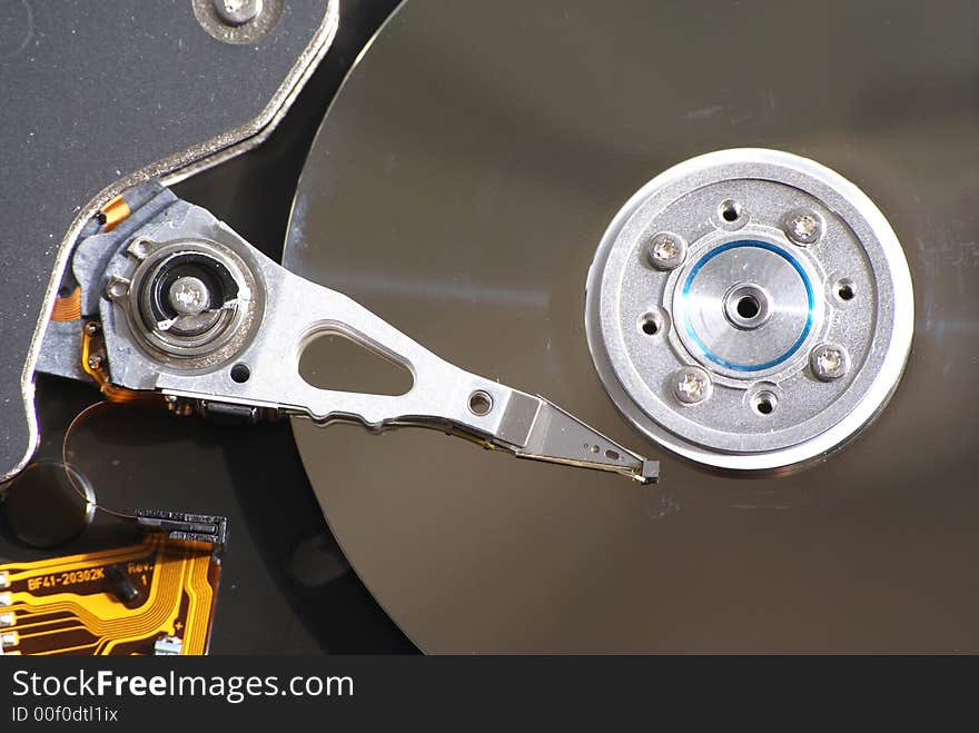 Opened hard drive on white background, closeup of head and disc. Opened hard drive on white background, closeup of head and disc