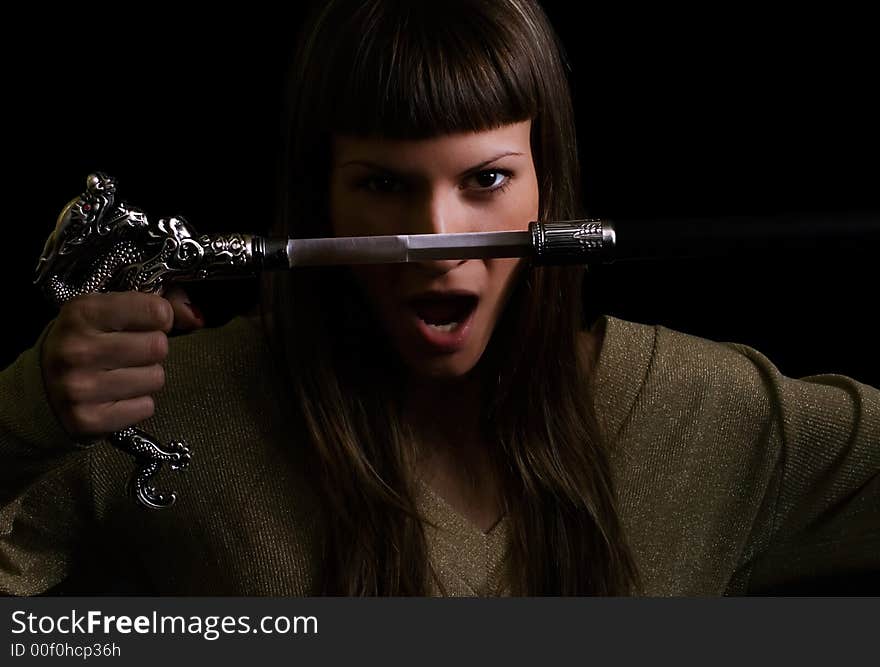 Dangerous girl holding a sword. Dangerous girl holding a sword