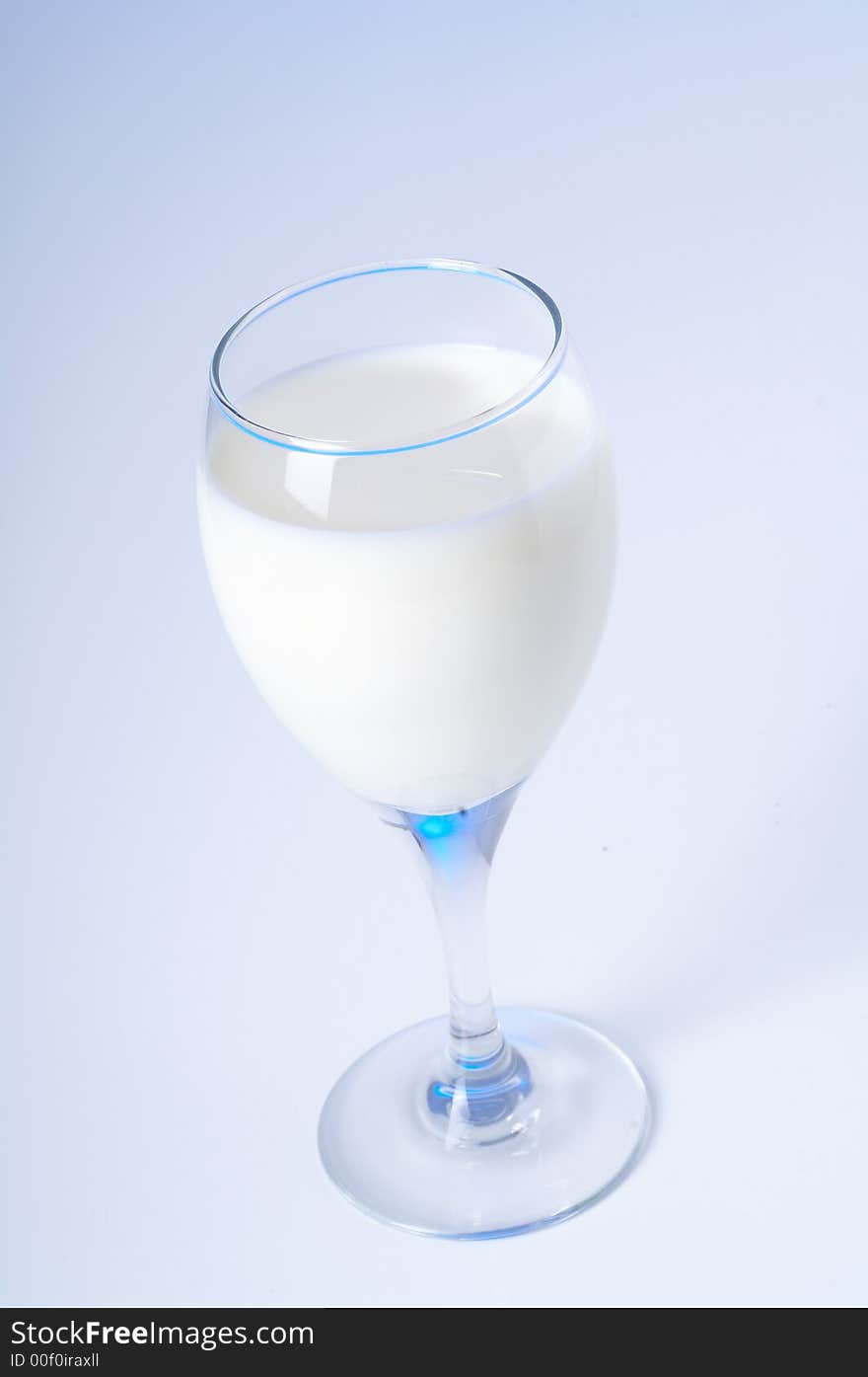 Glass of fresh milk and blue