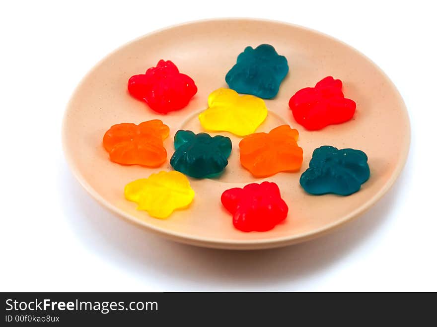 Beautiful fruit candy on a plate on a white background