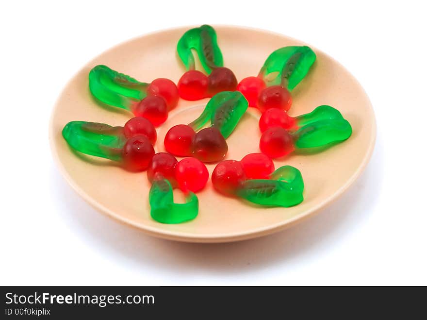 Beautiful fruit candy on a plate on a white background