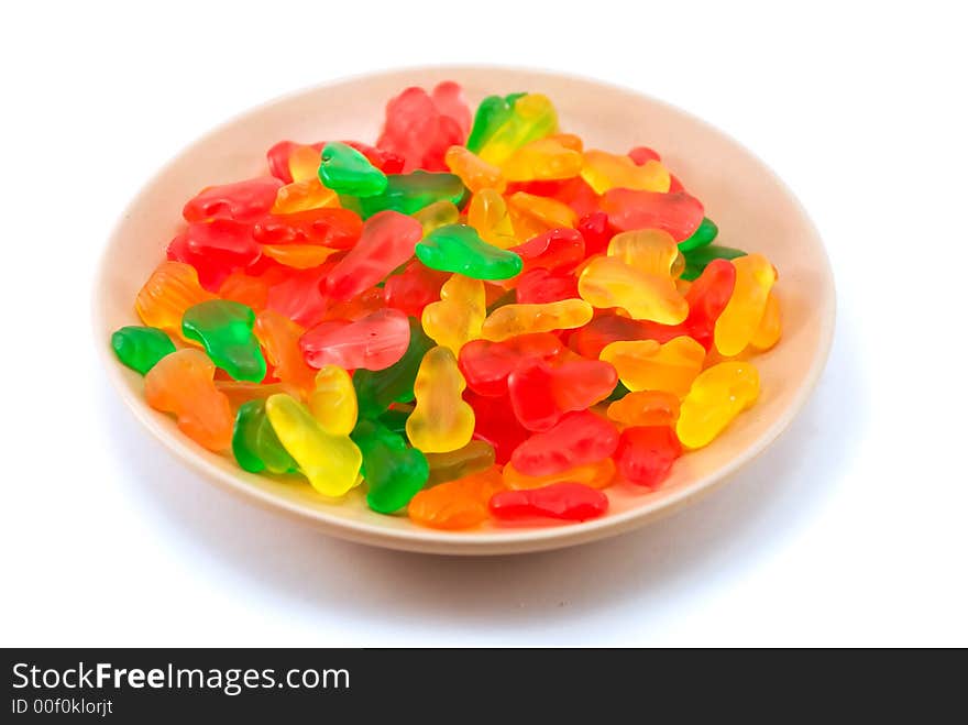 Beautiful fruit candy on a plate on a white background