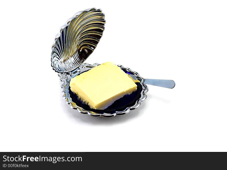 Beautiful butterdish with oil on a white background