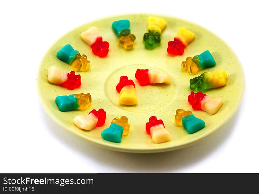 Beautiful fruit candy on a plate on a white background