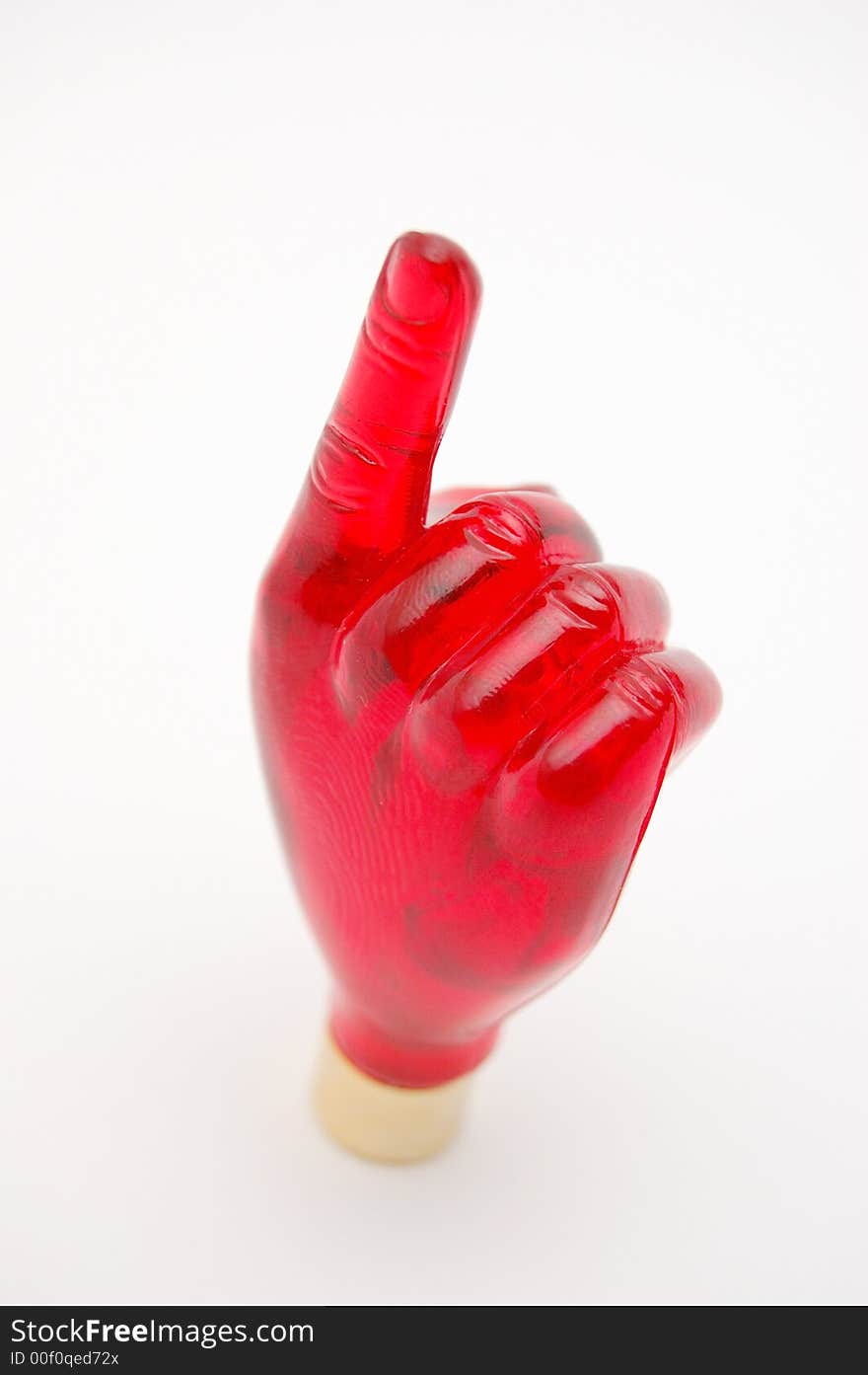 Red glass hand with index finger on white